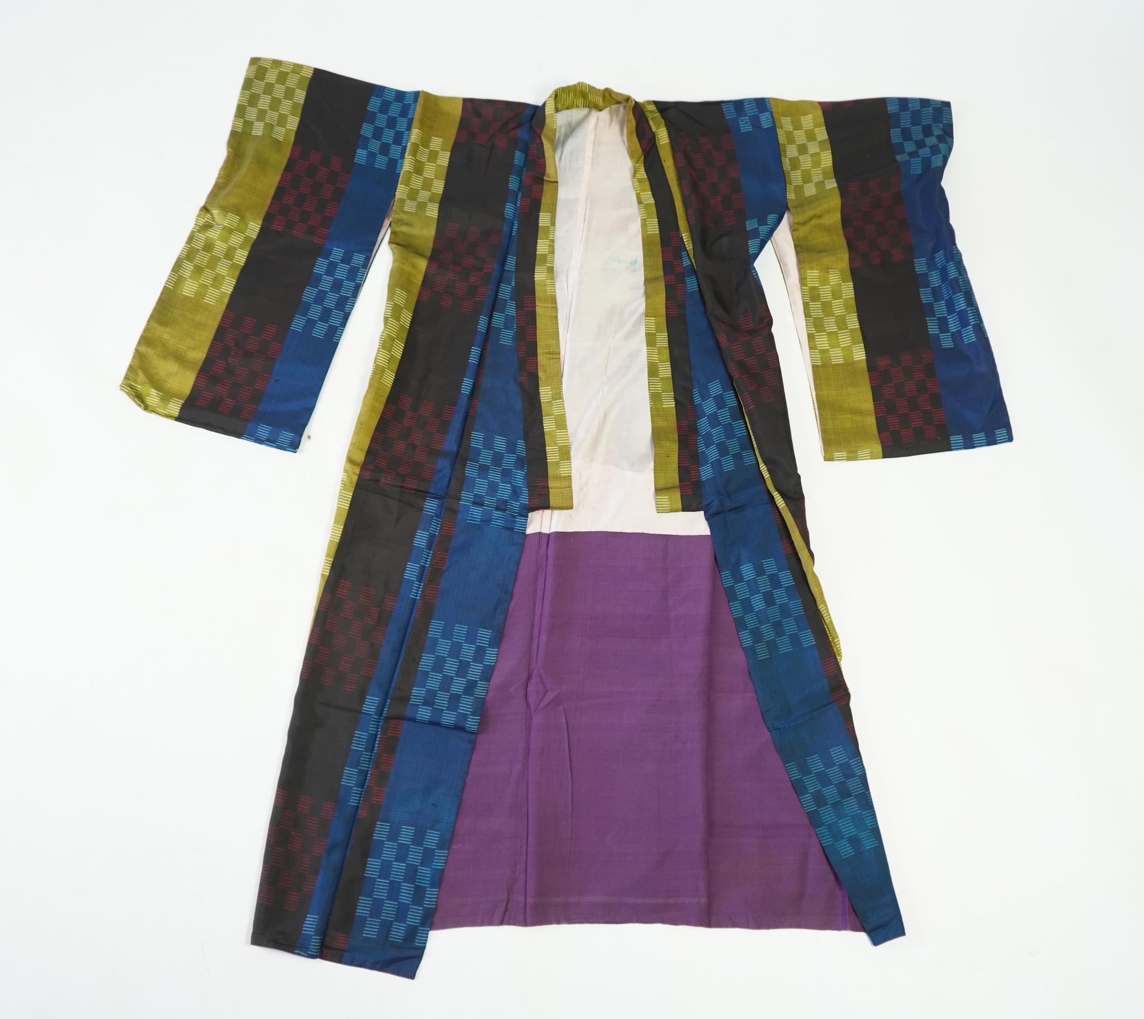 Four 1930’s - 1950’s printed silk full length silk lined Japanese kimonos. Two floral and two geometric in design. Longest black and orange floral designed kimono, 150cm long. Condition - purple and pink check kimono the
